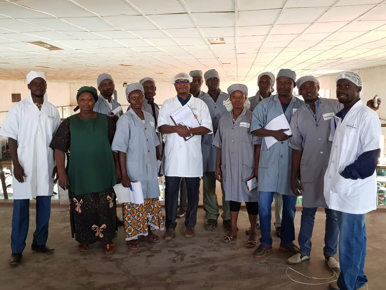 Group of trained participants in hygiene coats and caps